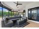Outdoor patio features a large sectional sofa, grill, and dining area with a view of the pool and greenery at 1484 Seafarer Dr, Osprey, FL 34229