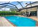 Screened in pool and spa with an outdoor kitchen and plenty of room for outdoor seating and entertaining at 1484 Seafarer Dr, Osprey, FL 34229
