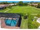 Screened-in pool area with pool and deck space surrounded by greenery at 1484 Seafarer Dr, Osprey, FL 34229