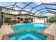 A large screened-in pool and spa area, perfect for entertaining, with an outdoor kitchen and patio at 1484 Seafarer Dr, Osprey, FL 34229