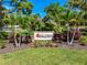 Community entrance sign for Southbay Yacht & Racquet Club surrounded by green foliage and palm trees at 1484 Seafarer Dr, Osprey, FL 34229