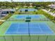Aerial view of well-maintained blue and green community tennis courts at 1484 Seafarer Dr, Osprey, FL 34229