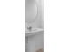 Stylish bathroom with pedestal sink and round mirror at 16652 Bergamo Pl, Bradenton, FL 34211