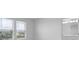 A bright bedroom with neutral walls, view out the window, and a glimpse of ensuite bathroom at 16652 Bergamo Pl, Bradenton, FL 34211