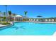Inviting community pool with sun loungers, umbrellas and cabana at 16652 Bergamo Pl, Bradenton, FL 34211