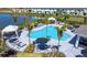 Aerial view of resort style pool with cabanas, umbrellas, and lounge chairs at 16652 Bergamo Pl, Bradenton, FL 34211