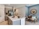 Modern kitchen with an island and stainless steel appliances flows into the dining area at 16652 Bergamo Pl, Bradenton, FL 34211