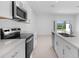Modern kitchen featuring stainless steel appliances, white cabinets and bar seating at 16652 Bergamo Pl, Bradenton, FL 34211