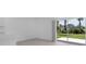 Open living area with sliding glass doors overlooking a backyard with well maintained lawn at 16652 Bergamo Pl, Bradenton, FL 34211