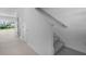Staircase with carpeted steps and a white handrail in a bright, naturally lit entryway at 16652 Bergamo Pl, Bradenton, FL 34211