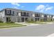 Attractive street view showcasing a line of townhomes, each with its own garage and neatly manicured lawn at 16652 Bergamo Pl, Bradenton, FL 34211