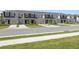 Row of modern townhomes with garages and well-maintained landscaping, creating a neat and appealing community aesthetic at 16652 Bergamo Pl, Bradenton, FL 34211
