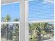 Bright window with blinds overlooking lush, green landscaping and sunny skies at 16652 Bergamo Pl, Bradenton, FL 34211