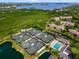 Panoramic aerial shot showcasing the community's tennis courts, pool, and surrounding natural beauty at 1684 Pintail Way, Sarasota, FL 34231