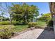 Peaceful backyard area with patio, manicured shrubs, and a lake with a fountain feature at 1684 Pintail Way, Sarasota, FL 34231
