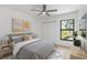Comfortable bedroom with a ceiling fan, modern decor and a view of outdoor landscape at 1684 Pintail Way, Sarasota, FL 34231