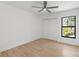 Bright bedroom features wood-look floors, a modern ceiling fan, and large closet at 1684 Pintail Way, Sarasota, FL 34231
