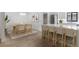 Open dining area flowing seamlessly into the kitchen, featuring modern light fixtures and ample seating at 1684 Pintail Way, Sarasota, FL 34231