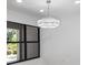 Bright dining area with modern lighting and a view of the outdoor landscape at 1684 Pintail Way, Sarasota, FL 34231