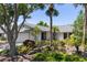 Well-maintained home exterior with lush landscaping and mature trees in a peaceful neighborhood at 1684 Pintail Way, Sarasota, FL 34231