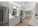 Modern white kitchen with stainless steel appliances, quartz countertops, and ample cabinet space at 1684 Pintail Way, Sarasota, FL 34231