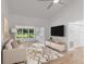 Stylish living room featuring a vaulted ceiling, modern furnishings, and large bright windows at 1684 Pintail Way, Sarasota, FL 34231