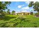 Expansive backyard showcasing vibrant green grass and a well-maintained lawn at 20 Idle Sands Dr, Venice, FL 34293