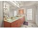 Bathroom featuring a double sink vanity, a large mirror, and good lighting at 20 Idle Sands Dr, Venice, FL 34293