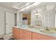 Bathroom with dual sinks, ample counter space, and a shower with a stylish shower curtain at 20 Idle Sands Dr, Venice, FL 34293