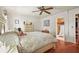 Comfortable bedroom with neutral decor and hardwood floors, adjoined to ensuite bathroom at 20 Idle Sands Dr, Venice, FL 34293