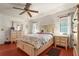 Comfortable bedroom with neutral decor and hardwood floors, featuring a plush bed and natural light at 20 Idle Sands Dr, Venice, FL 34293