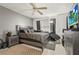 This bedroom offers a contemporary design with a ceiling fan, large window, and dark furniture at 20 Idle Sands Dr, Venice, FL 34293