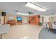 Large community room with a TV, ceiling fan, and kitchenette area at 20 Idle Sands Dr, Venice, FL 34293