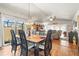 Elegant dining room with hardwood floors, stylish chandelier, and sliding door to patio at 20 Idle Sands Dr, Venice, FL 34293