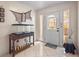 Bright foyer featuring tile flooring, a decorative fish tank, and a stylish front door at 20 Idle Sands Dr, Venice, FL 34293