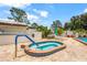 A private hot tub with tiled surround, lounge chairs and privacy fence at 20 Idle Sands Dr, Venice, FL 34293