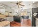 Functional kitchen with modern appliances, a movable island, and an adjacent dining area at 20 Idle Sands Dr, Venice, FL 34293