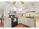 Well-lit kitchen with white cabinets, a stainless steel microwave, and tiled backsplash at 20 Idle Sands Dr, Venice, FL 34293