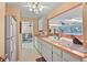 Traditional kitchen with pass through, white cabinetry and spacious countertops at 20 Idle Sands Dr, Venice, FL 34293