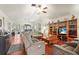 Cozy living room with hardwood floors, a ceiling fan, and access to the dining area at 20 Idle Sands Dr, Venice, FL 34293