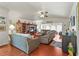 Bright living room with hardwood floors, neutral furniture, and a vaulted ceiling at 20 Idle Sands Dr, Venice, FL 34293