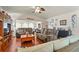 Spacious living room with hardwood floors, comfortable seating, and ample natural light at 20 Idle Sands Dr, Venice, FL 34293
