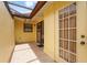 This is a patio featuring tile flooring, a neutral wall, and a glass door and window at 20 Idle Sands Dr, Venice, FL 34293
