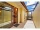 Enclosed patio featuring tile flooring, light yellow walls, and entry to kitchen and exterior at 20 Idle Sands Dr, Venice, FL 34293