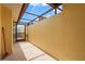 This is a patio featuring tile flooring, a neutral wall, and a metal frame overhead at 20 Idle Sands Dr, Venice, FL 34293