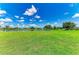 Expansive backyard with lush green lawn, offering a tranquil lakeside setting and serene neighborhood views at 208 147Th Ne St, Bradenton, FL 34212