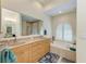 This bathroom features a double sink vanity, soaking tub beneath an arch window with plantation shutters, and a tiled shower at 208 147Th Ne St, Bradenton, FL 34212