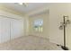 Bright bedroom with neutral paint, carpeted floors, a window with shutters, and a closet with double doors at 208 147Th Ne St, Bradenton, FL 34212