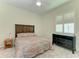 Cozy bedroom featuring wood furniture, a patterned bedspread, and natural light from a window at 208 147Th Ne St, Bradenton, FL 34212