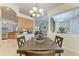 Bright dining space featuring tray ceilings, architectural columns and an open flow to the kitchen and living room at 208 147Th Ne St, Bradenton, FL 34212